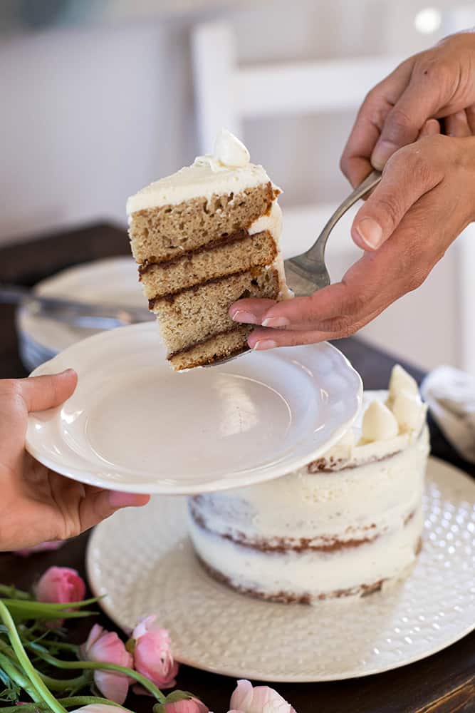 hands serving a slice gluten free banana cake