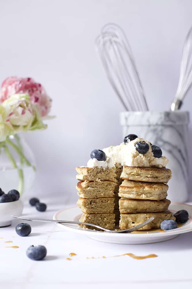 oat flour pancakes with blueberries and whipped cream