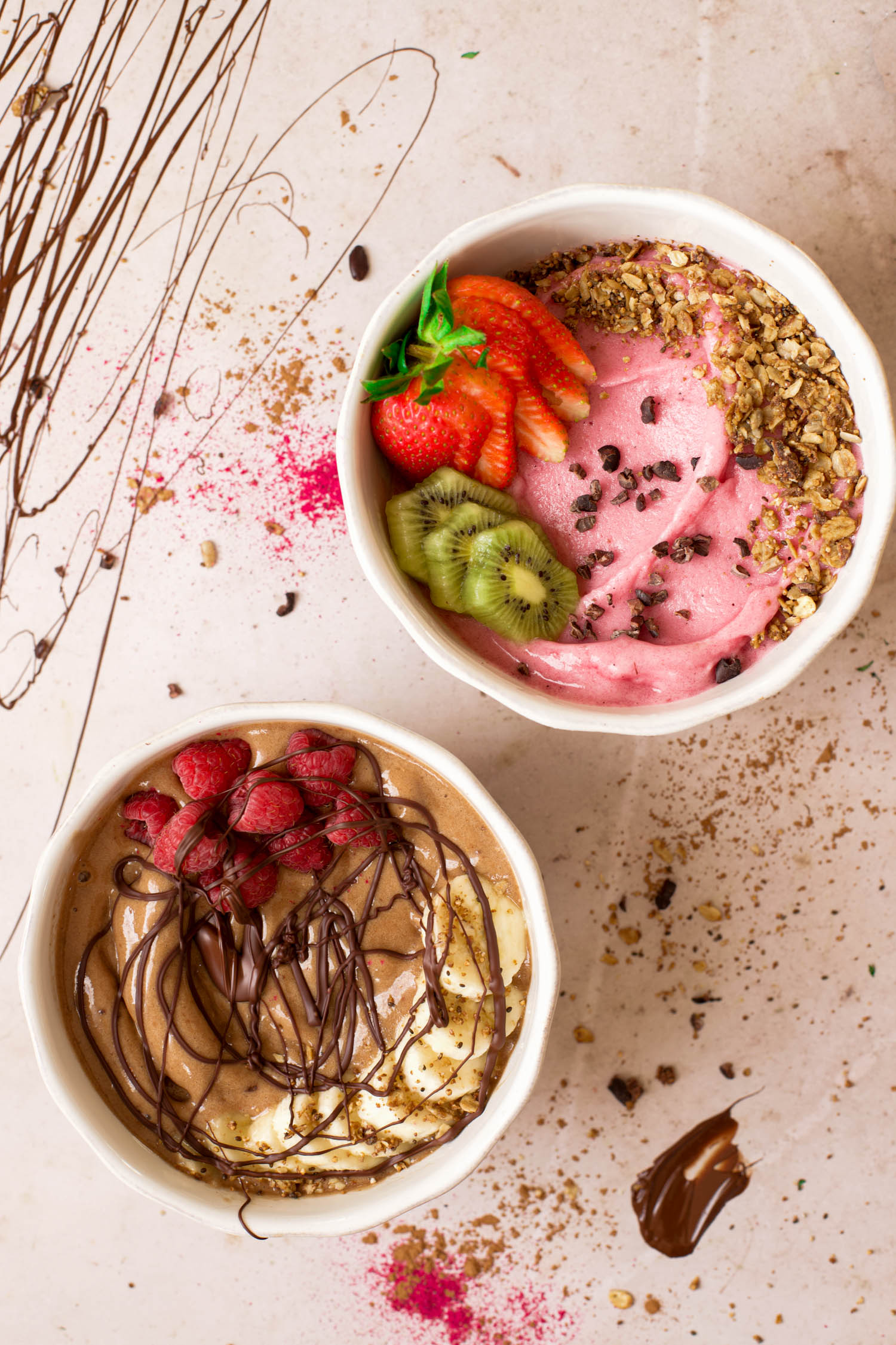 Two smoothie bowls with toppings