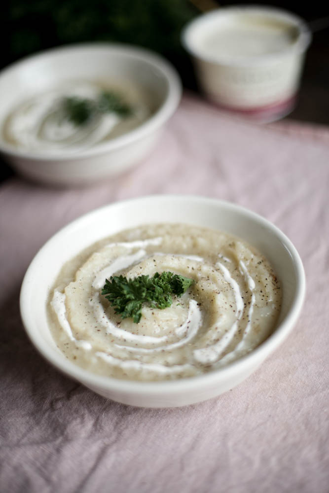bowl of gluten free potato soup garnished with parsley